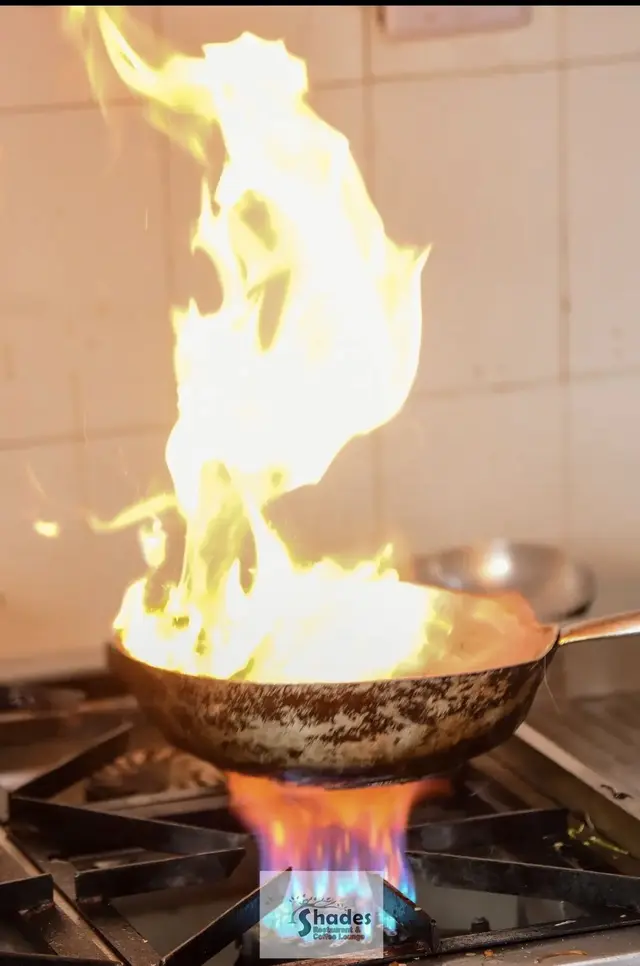 Flames leaping from a pan in the Shades kitchen